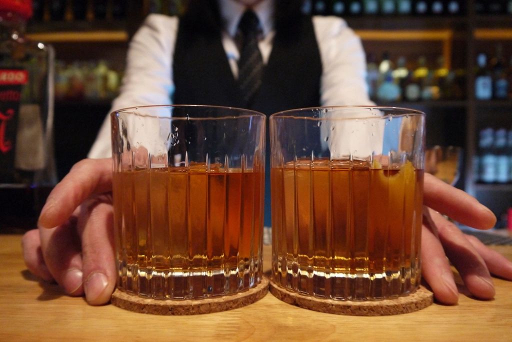 A cocktail being finished at the bar
