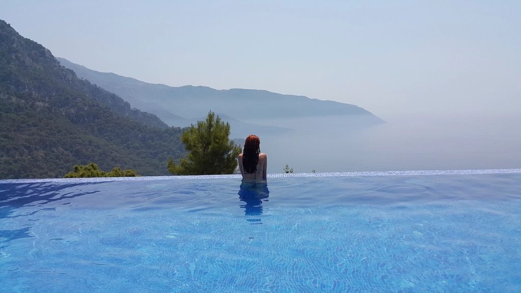The outdoor swimming pool with loungers alongside