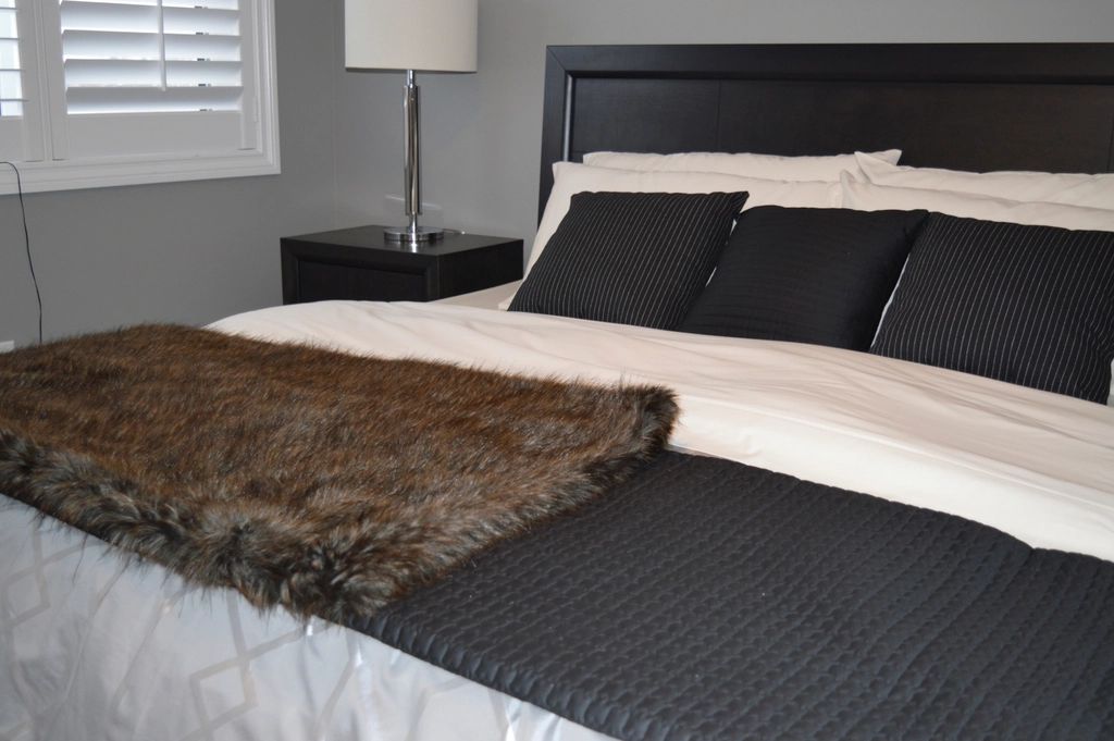 A guest room with a large bed and soft lighting